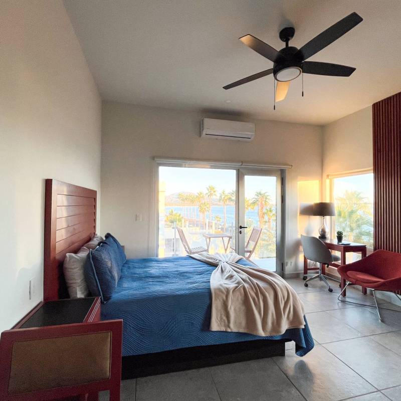 Junior suite with king bed and ocean-view balcony at Baja Mía Loreto